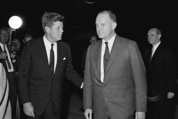 President John F. Kennedy speaks with Secretary of the Treasury C. Douglas Dillon upon the return of the delegation to the Inter-American Economic and Social Conference at Punta del Este on the South Lawn, White House, Washington, D.C. Secretary of State Dean Rusk looks on from behind Secretary Dillon. 19 August 1961. Robert Knudsen. White House Photographs. John F. Kennedy Presidential Library and Museum, Boston. Public Domain.