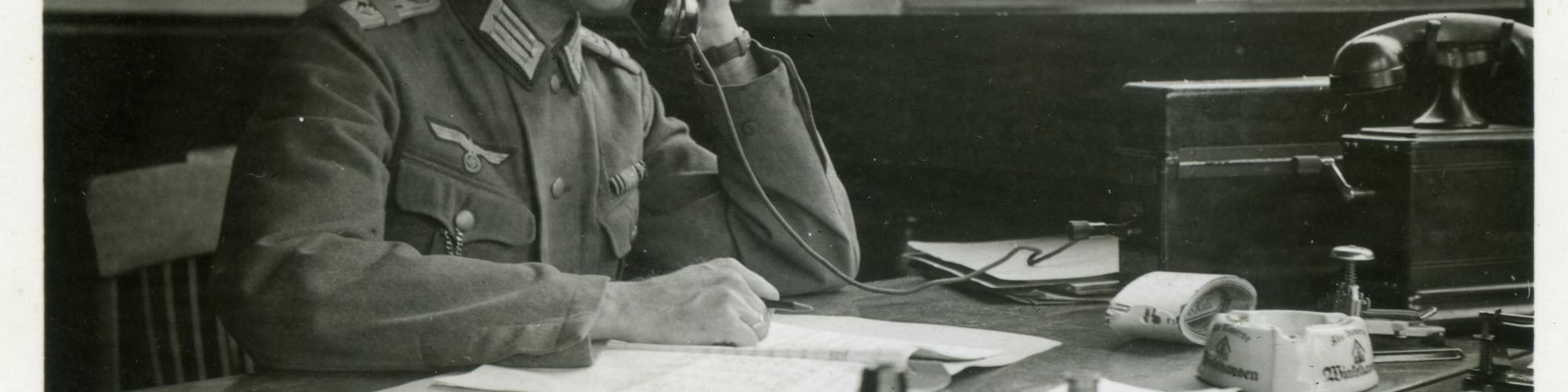 A German officer in a Belgian office at Mons railway station. The Wehrmacht Verkehrs Direktion aggressively takes over large parts of SNCB's strategic and operational business management. Source: private collection Paul Pastiels.